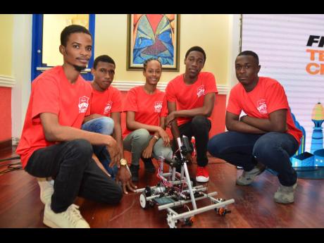 The Glenmuir High School robotics team poses with their robot at the launch of the robotics competition held at the NCB Wellness & Recreation Centre on Phoenix Avenue in St Andrew yesterday. The team is (from left) coach Christopher Myrie, Winston Banton, Toni-Ann Burrell, Tariq Kelly, and Michael Crawford.