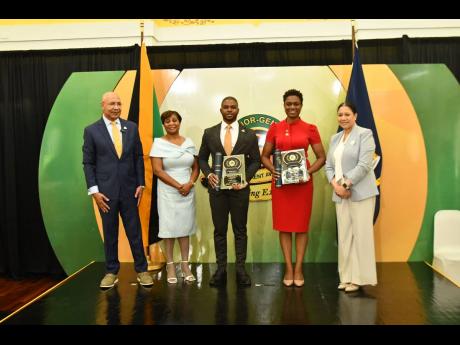 Governor General Sir Patrick Allen (left), his wife Lady Allen (second left) and Edith Chin (right), custos of Clarendon, with awardees for Clarendon, O’rane Thomas and Winsome Marcia Sherrier Witter, duing the Governor General’s Achievement Awards Ceremony held at King’s House in St Andrew on June 26.